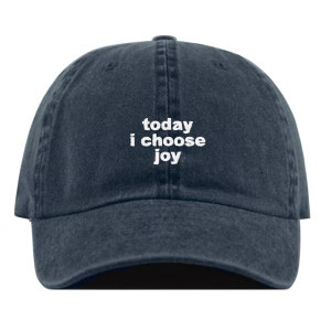 May include: A dark blue denim baseball cap with white embroidered text that reads "today i choose joy".
