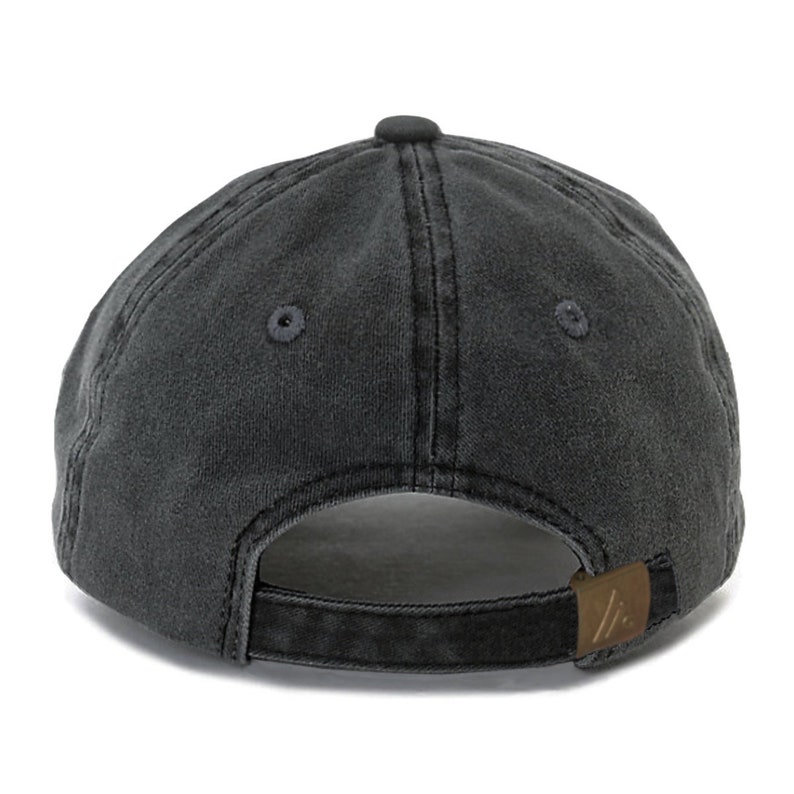 May include: A black, washed cotton baseball cap with a brown leather adjustable strap and a small logo on the back.