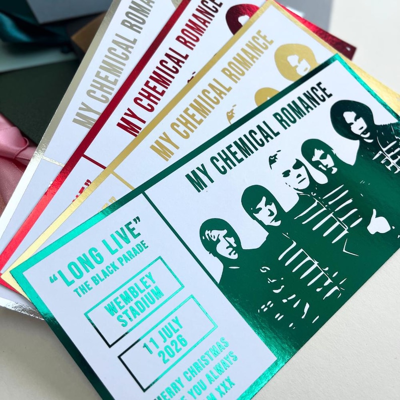 May include: A collection of concert tickets with the text "MY CHEMICAL ROMANCE" in gold, red, and green foil. The tickets feature band member silhouettes and details for a Wembley Stadium show on July 11, 2026, with the text "LONG LIVE THE BLACK PARADE".