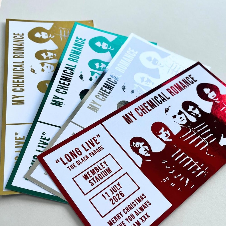 May include: A collection of concert tickets featuring the band My Chemical Romance. The tickets have a variety of colors, including gold, teal, silver, and red. The text on the tickets includes "LONG LIVE" and the date "11 JULY 2026".