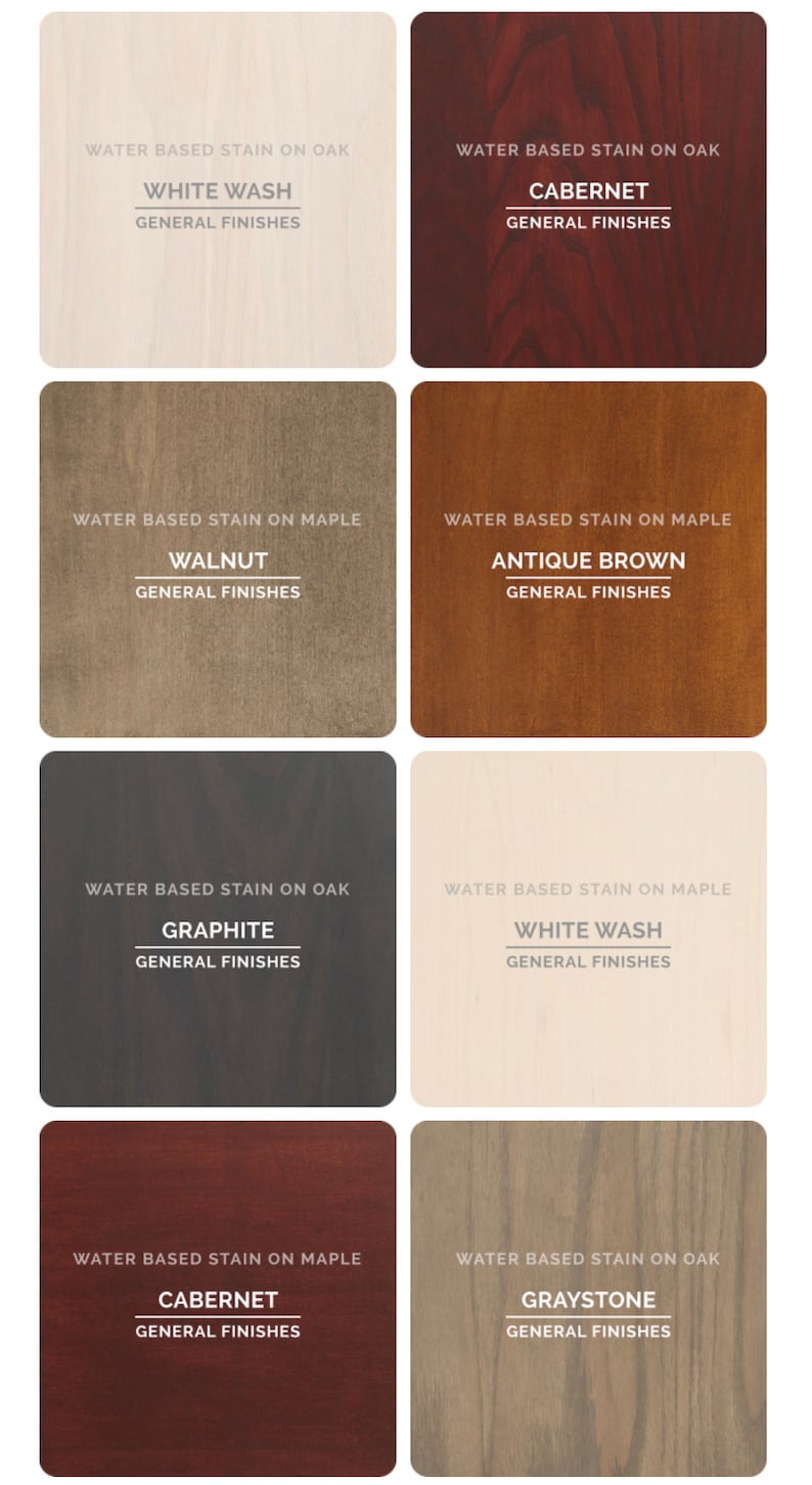 May include: Eight wood stain samples on oak and maple wood. The stains are labeled with their names and the words "Water Based Stain" and "General Finishes". The stains are: White Wash, Cabernet, Walnut, Antique Brown, Graphite, White Wash, Cabernet, Graystone.