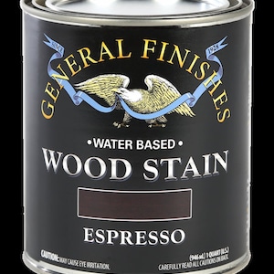 May include: A can of General Finishes Espresso Wood Stain. The can is black with gold lettering and an eagle logo. It is water-based and contains 1 quart (946 ml).