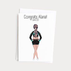 May include: A greeting card with the text "Congrats Alana! Summit 2026" features an illustration of a person in a black and teal cheerleading uniform. The person is viewed from the back, with their arms at their sides and legs crossed. The card is white with a white envelope.