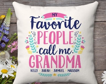 May include: White throw pillow with a pink and blue floral design. The text reads "My Favorite People Call Me Grandma" with the names Kelly, Sarah, Samuel, and Madison listed below.