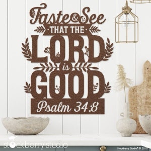 May include: Brown metal wall art with the text "Taste & See That The Lord Is Good Psalm 34:8" with decorative leafy accents.