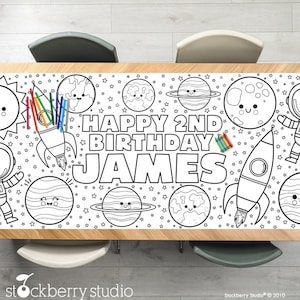 May include: A black and white coloring table runner featuring a rocket, planets, stars, and the text "HAPPY 2ND BIRTHDAY JAMES".
