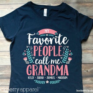 May include: Navy blue t-shirt with the text "My Favorite People Call Me Grandma" in pink and white. The names Kelly, Sarah, Samuel, and Madison are listed below the text.