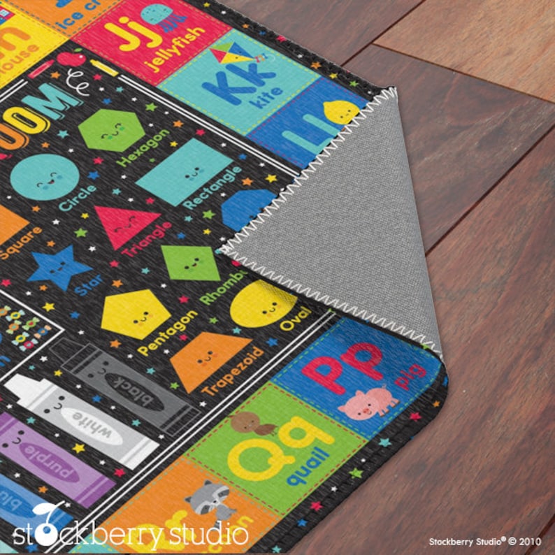 May include: A colorful alphabet and shapes learning rug with a black background. The rug features letters, shapes, and animals with a playful design. The rug is perfect for children's playrooms or classrooms.