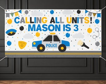 May include: A white banner with the text "CALLING ALL UNITS! MASON IS 3" in blue and yellow. The banner features a blue and white police car, balloons, and police-themed graphics. A fun decoration for a child's birthday party.