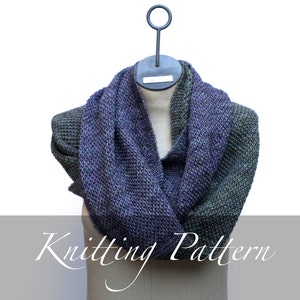 May include: A knitted scarf in shades of green and purple, displayed on a mannequin. The scarf is a simple, textured knit and is a great addition to any winter wardrobe. Knitting Pattern.