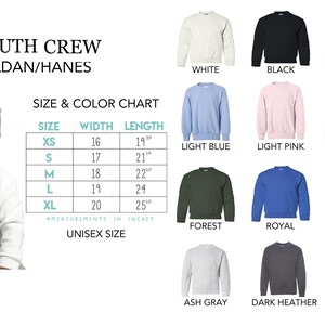 May include: Youth crew neck sweatshirt size chart with measurements in inches. The chart shows sizes XS to XL with corresponding width and length measurements. The chart is displayed next to a variety of color options for the sweatshirt, including white, black, red, light blue, light pink, navy, forest, royal, sport gray, ash gray, dark heather, and chocolate.