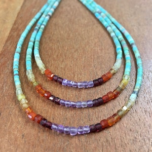 May include: A multi-strand necklace with turquoise, carnelian, amethyst, and citrine beads. The necklace is made of small, square-shaped beads.