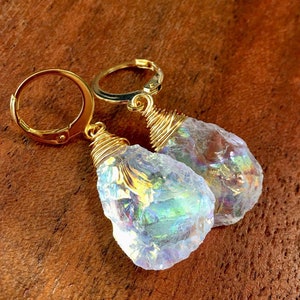 May include: A pair of gold wire wrapped earrings with iridescent white gemstone drops.