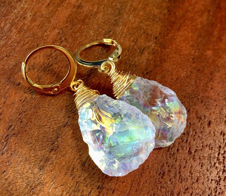 May include: A pair of gold wire wrapped earrings with iridescent white gemstone drops.