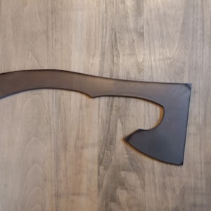 May include: A black axe with a curved handle. The axe is made of metal and has a sharp blade.