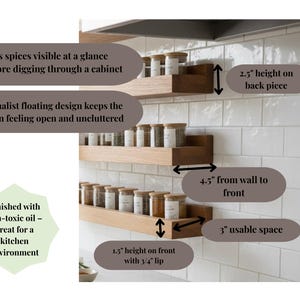 May include: Wooden spice rack with three shelves, each holding spice jars. The design is minimalist and floating, with dimensions of 4.5 inches from the wall to the front, 2.5 inches height on the back piece, and 1.5 inches height on the front with a 3/4 inch lip.