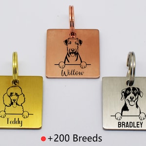 May include: Three personalized dog tag keychains with different dog breeds. The keychains are made of gold, copper, and silver metal. The tags feature a black and white silhouette of a dog with the dog's name engraved below. The text on the tags reads "Teddy", "Willow", and "Bradley".  +200 Breeds
