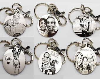 May include: A collection of engraved metal keychains. Each keychain features a different engraved image, including portraits of people, a dog, and a child with a rocking horse. Some keychains have text, such as "Cali" and "My Besties x".