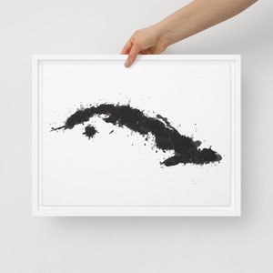 May include: A black and white watercolour painting of the island of Cuba. The island is depicted in a stylised, abstract way, with splashes of black paint representing the coastline and interior.