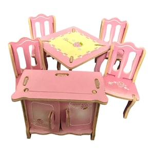 May include: A pink wooden doll's furniture set, comprising a table, four chairs, and a cabinet. The table features a yellow centre with a strawberry design. The chairs and cabinet are pink with strawberry and floral accents.