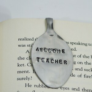 May include: A silver spoon bookmark with the words "AWESOME TEACHER" stamped on it.