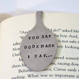May include: A silver spoon bookmark with the text "You Say Bookmark I Say..." engraved on it.