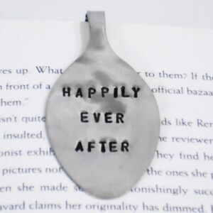 May include: A silver spoon with the words "Happily Ever After" engraved on it. The spoon is a wedding or anniversary gift.