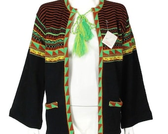 May include: Black cardigan with a green, orange, and yellow geometric pattern. The cardigan has a tie closure with a green tassel.