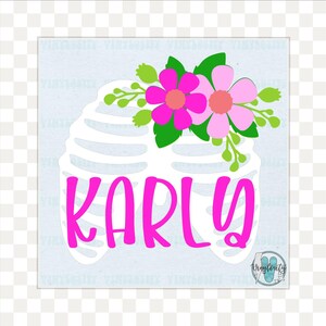 May include: A white rib cage design with the name "KARLY" in bright pink, topped with pink flowers and green leaves. The design is on a light blue background. The image has a floral and anatomical theme.