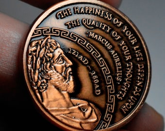 May include: A copper-colored coin with a profile of Marcus Aurelius, a Roman emperor, and the inscription "THE HAPPINESS OF YOUR LIFE DEPENDS UPON THE QUALITY OF YOUR THOUGHTS - MARCUS AURELIUS, 121AD - 180AD".