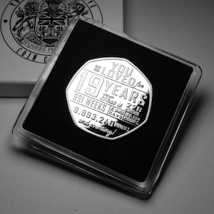 May include: A silver coin with the inscription "You Loved for 19 Years" and the text "That is 228 Months, 6,940 Days, 168,964 Hours, 9,993,240 Minutes and counting!"