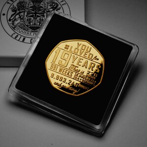 May include: A gold-colored coin with the inscription "You Loved for 19 Years" and the text "That is 22 Years, 991 Weeks, 6,940 Days, 166,560 Hours, 9,993,240 Minutes and counting!"