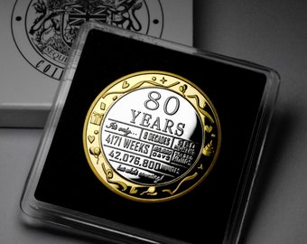 May include: A gold and silver coin with the number 80 and the words "80 YEARS" on it. The coin also has the text "It's only... 8 DECADES 4171 WEEKS 42,076,800 minutes... who's counting!" on it.
