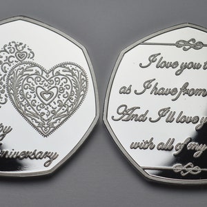 May include: Silver coin with a heart design and the words "Happy Anniversary" on one side and the text "I love you today as I have from the start. And I'll love you forever with all of my heart." on the other side.