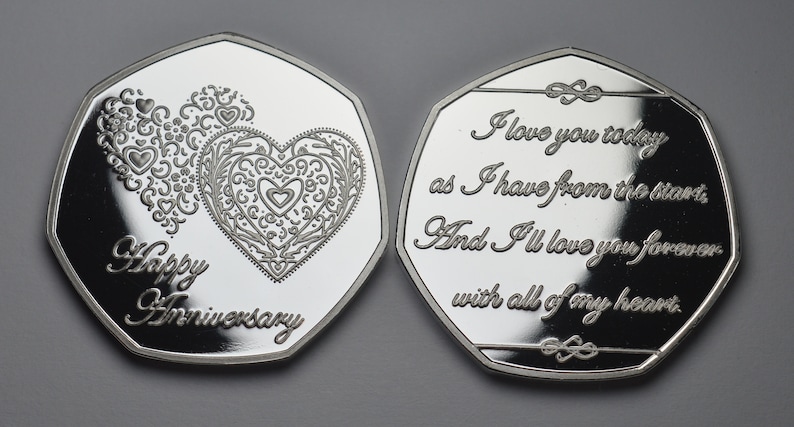 May include: Silver coin with a heart design and the words "Happy Anniversary" on one side and the text "I love you today as I have from the start. And I'll love you forever with all of my heart." on the other side.