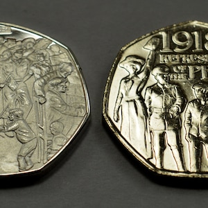 May include: Two silver commemorative coins celebrating the 1918 Representation of the People Act. The obverse features a group of people, while the reverse depicts a group of people holding a banner with the text "1918 Representation of the People Act."