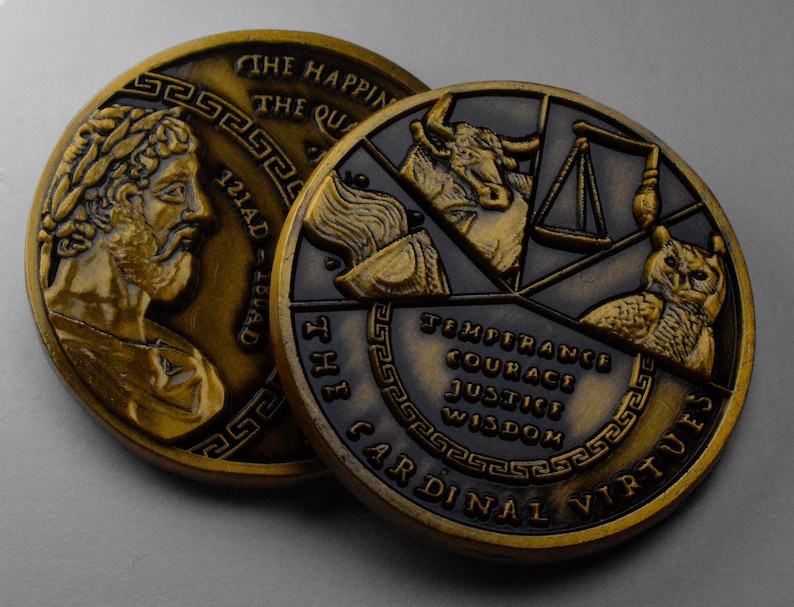 May include: Two gold-toned metal coins with raised edges. The first coin features a profile of a man with a laurel wreath on his head. The second coin features four symbols representing the cardinal virtues: temperance, courage, justice, and wisdom. The text "THE CARDINAL VIRTUES" is inscribed around the edge of the coin.