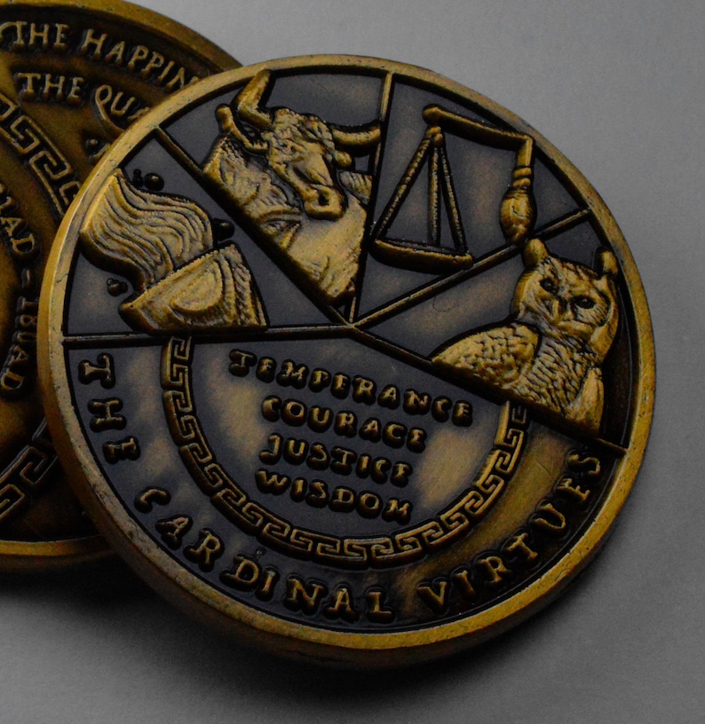 May include: A gold-toned metal coin with a black background. The coin features a design of four cardinal virtues: Temperance, Courage, Justice, and Wisdom. The coin is inscribed with "The Cardinal Virtues" around the edge.