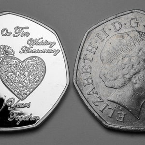 May include: A silver coin with a heart design and the text "For You On Our Tin Wedding Anniversary 10 Years Together". The other side of the coin features a profile of Queen Elizabeth II and the text "ELIZABETH II D.G. REG. F.D. 2001".