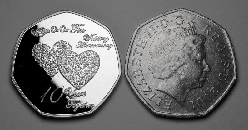 May include: A silver coin with a heart design and the text "For You On Our Tin Wedding Anniversary 10 Years Together". The other side of the coin features a profile of Queen Elizabeth II and the text "ELIZABETH II D.G. REG. F.D. 2001".