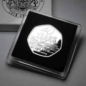 May include: A silver coin with the inscription "40 YEARS" and the text "That is... 480 Months 2087 Weeks 14609 Days 350,632 Hours 21,037,950 Minutes and still counting..."