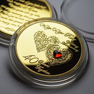 May include: Gold coin with a red ruby heart and the text "For You On Your Ruby Wedding Anniversary 40 Years Together".