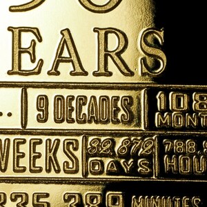 May include: A gold-coloured plaque with the inscription "30 Years", "9 Decades", "108 Months", "52 Weeks", "32,872 Days", "788,800 Hours", and "2,853,360 Minutes".