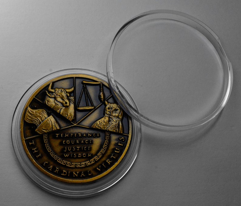 May include: A gold-toned coin with a design featuring a bull, scales, an owl, and the words "The Cardinal Virtues" and "Temperance, Courage, Justice, Wisdom". The coin is in a clear plastic case.
