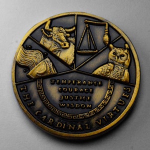 May include: A gold-toned metal coin with a black background. The coin features a bull, a scale, an owl, and a torch. The words "The Cardinal Virtues" are inscribed around the edge of the coin. The words "Temperance, Courage, Justice, Wisdom" are inscribed in the center of the coin.