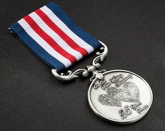 May include: A silver medal with a red, white, and blue ribbon. The medal features a heart design with the text "Our Silver Wedding Anniversary 25 Years Service".