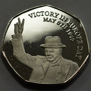 May include: Silver coin commemorating Victory in Europe Day, May 8th, 1945. The coin features a portrait of Winston Churchill raising his hand in victory.
