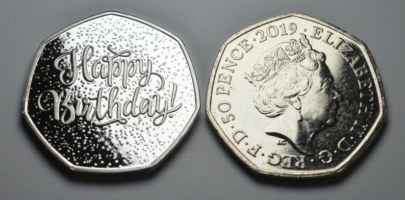 May include: A silver 50 pence coin with a design of Queen Elizabeth II on one side and the words "Happy Birthday!" on the other side. The coin is dated 2019.