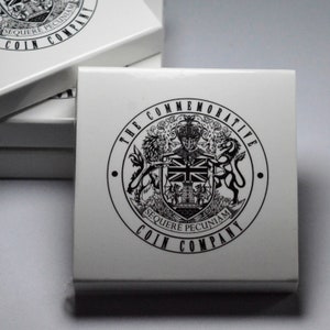 May include: A white box with a black and white logo that says "The Commemorative Coin Company" and "Sequare Pecuniam".