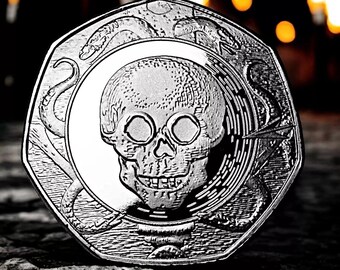 May include: A silver coin with a skull and snake design. The skull has a detailed face with a prominent nose and large eye sockets. The snake is coiled around the skull and has a sharp, pointed tail.